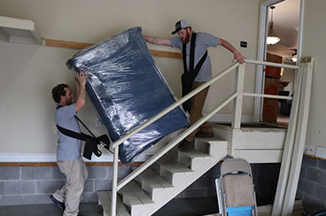 Making Moves Moving movers moving furniture downstairs.